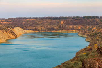 View of a lake with sandy shores in flooded sand quarry