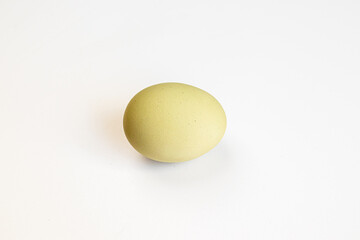 Multicolored village chicken eggs on a white background