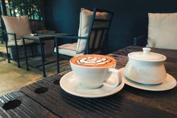 Coffee Cup on Wooden Table Coffee Cafe Shop, Closeup Coffee Mug and Smoothy Foam Cream on Topping for Breakfast in The Restaurant. Food Beverage and Restaurant Retro Vintage Lifestyles