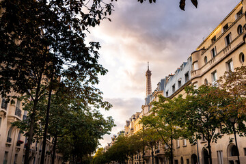 Peeping view of the Eiffel Tower on the streets of Paris with soft lighting
