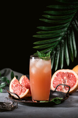Fresh grapefruits and glass of grapefruit juice
