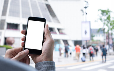 Mockup of man using mobile phone with blurred people shopping at department store