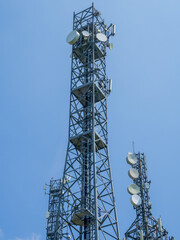 Group of towers for telecommunications, television broadcast, cellphone on mountain peak. Telecommunication center. Electromagnetic and environmental pollution