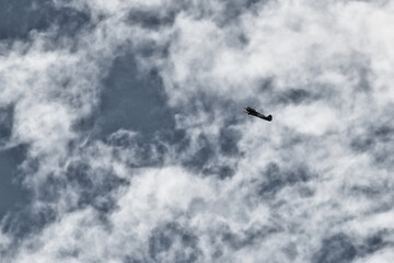 a sports plane flies in the sky. old film, noise
