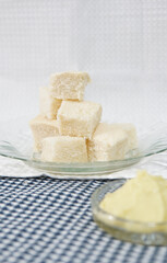 Diced white bread cubes in a glass plate with custard dip