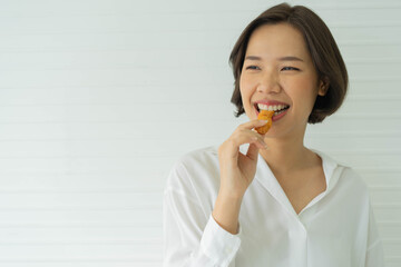 close up asian woman hold protein cereal bar to eat in the midday for health and lifestyle concept