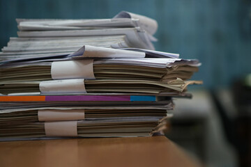 Stack of business report paper files on desk