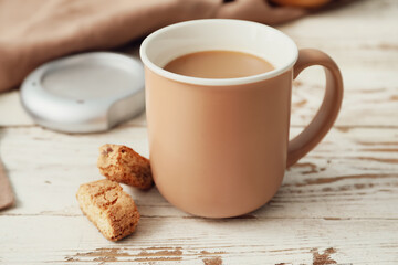 Cup of coffee with cookies on table