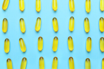 Fish oil capsules on color background