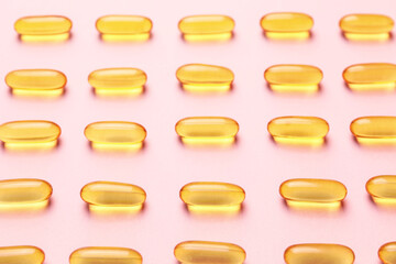 Fish oil capsules on color background
