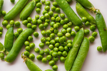 Green fresh peas isolated on white top view.