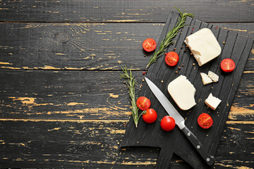 Tasty feta cheese with olives, tomato and spices on table