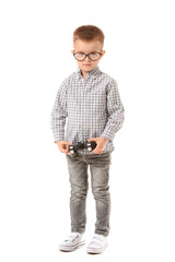 Cute little boy with game pad on white background