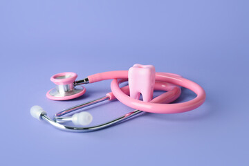 Tooth with stethoscope on color background