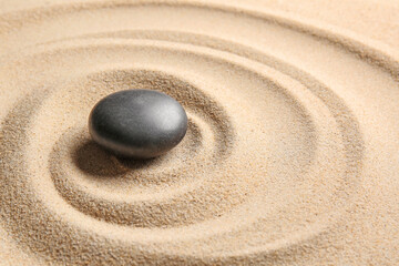 Fototapeta na wymiar Stone on sand with lines. Zen concept