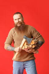 Handsome lumberjack on color background