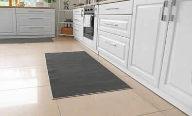 Stylish carpet on floor in modern kitchen