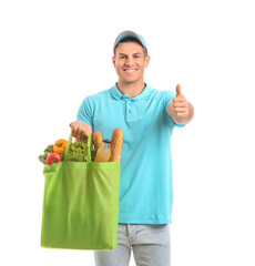 Delivery man with food in bag showing thumb-up gesture on white background