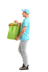 Delivery man with food in bag on white background