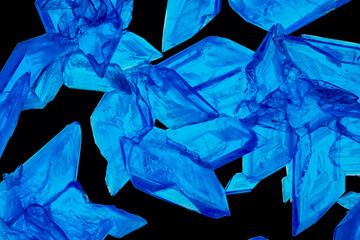 Beautiful crystals of Copper Sulphate shown in close-up and isolated against a black background. Copper Sulfate is used in industry, agriculture and medicine and is commonly used in school science. 
