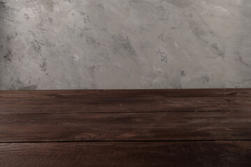 Image of wooden table in front of blurred background. Empty wooden table platform over background for present product.