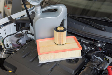 Engine oil and oil filter in the background of the engine compartment of a car