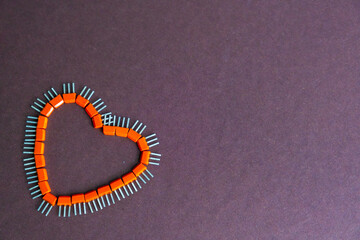 Happy father's day - heart made of transistors on a brown background. Flat composition of...