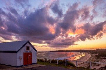 Fototapeta na wymiar Colourful sunset over Lighthouse Beach.Lighthouse keepers shed in foreground. Myall Lakes National Park. Mid North Coast of N.S.W. Australia.