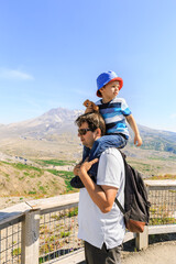 Fototapeta na wymiar Father and son who looks back near Mt. St. Helens