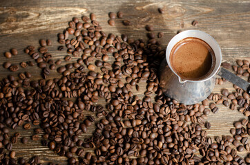 a cup of coffee with sprinkled coffee beans on the table