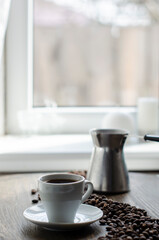 cup of coffee on the background of the window
