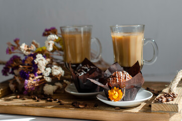 chocolate muffins on the table with a cup of coffee
