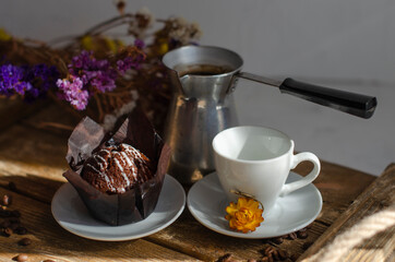 chocolate muffins on the table with a cup of coffee