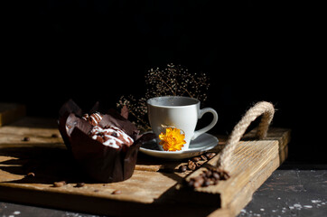 cup of coffee on the table with cupcakes