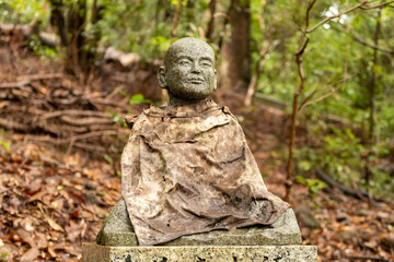 Wayside stone carved Buddha statue in japanese park in Nara, Japan.