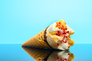 fresh vanilla and strawberry flavor ice cream cone on a glass with reflection
