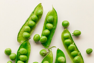 Green fresh peas ans pea pods isolated on white top view.