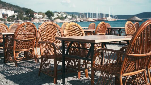 An empty cafe by the sea in the resort town is waiting for guests and clients, empty city spaces. Summer vacation concept