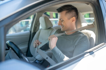 Interested man in drivers seat in car