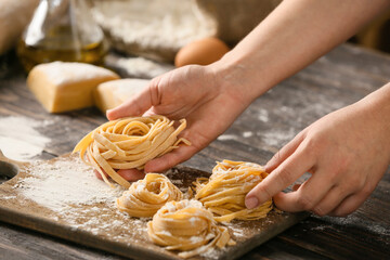 Woman preparing pasta in kitchen, closeup