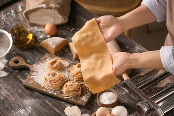 Woman preparing pasta in kitchen, closeup