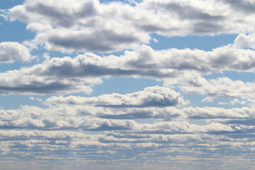 Fototapeta premium White fluffy clouds on a background of blue sky in summer. The concept of weather and climate
