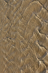 abstract effect of water movement on a sandy bottom with sunny reflections