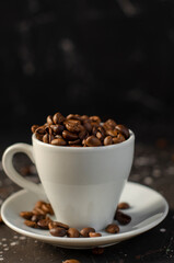 coffee beans in a small white cup. sprinkled coffee beans
