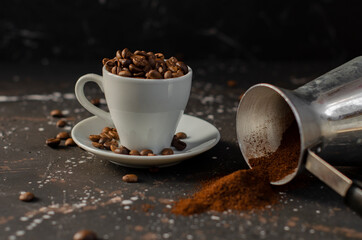 coffee beans in a small white cup. sprinkled coffee beans