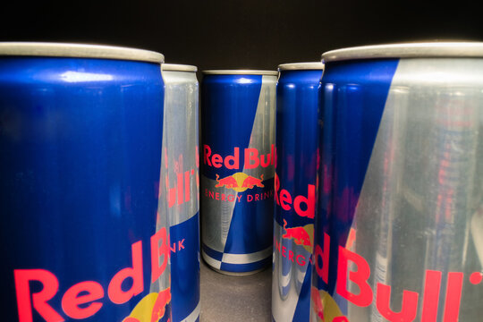 PRAGUE, CZECH REPUBLIC - April 16th, 2019: wide angle view of aluminum Red Bull energy drink can on dark background. Redbull drink is popular in youth culture and sport sports industry