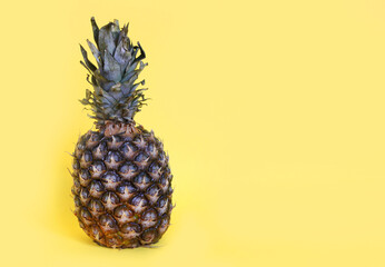 A pineapple on yellow paper background