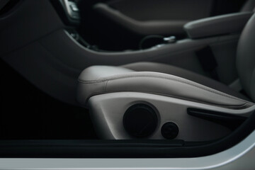 Obraz na płótnie Canvas Modern car leather seat with adjustment close up