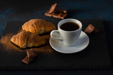 cup of coffee with chocolate croissants on the table