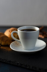 cup of coffee with chocolate croissants on the table